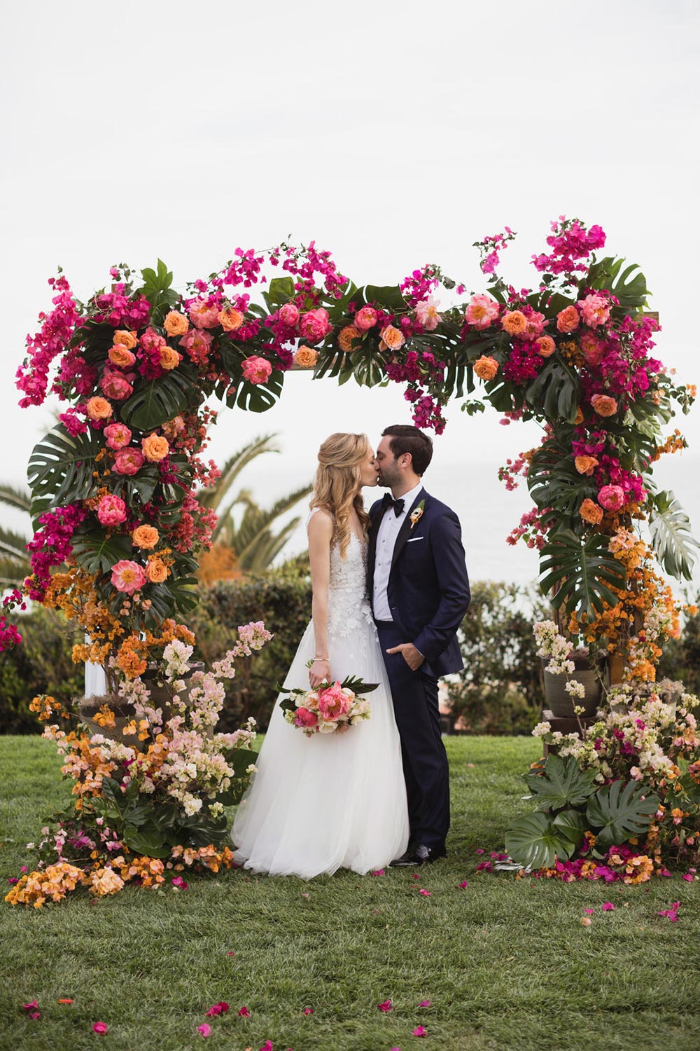 floral appliqué wedding dress with navy groom tuxedo