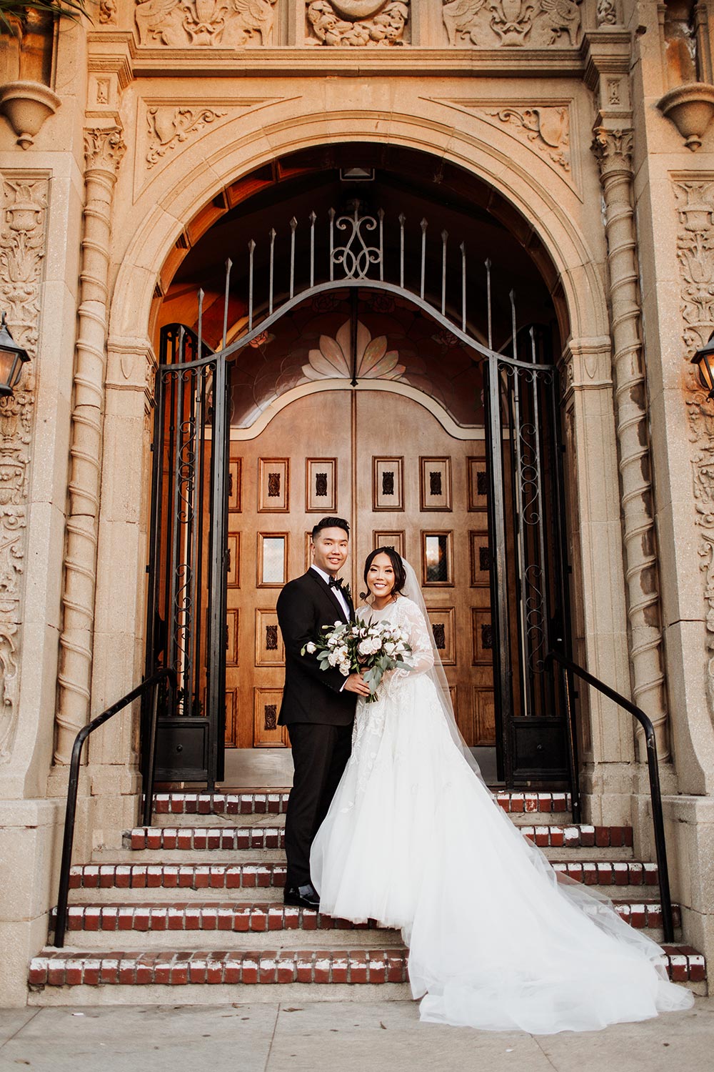 long sleeve tulle wedding dress and black groom tux historic wedding venue